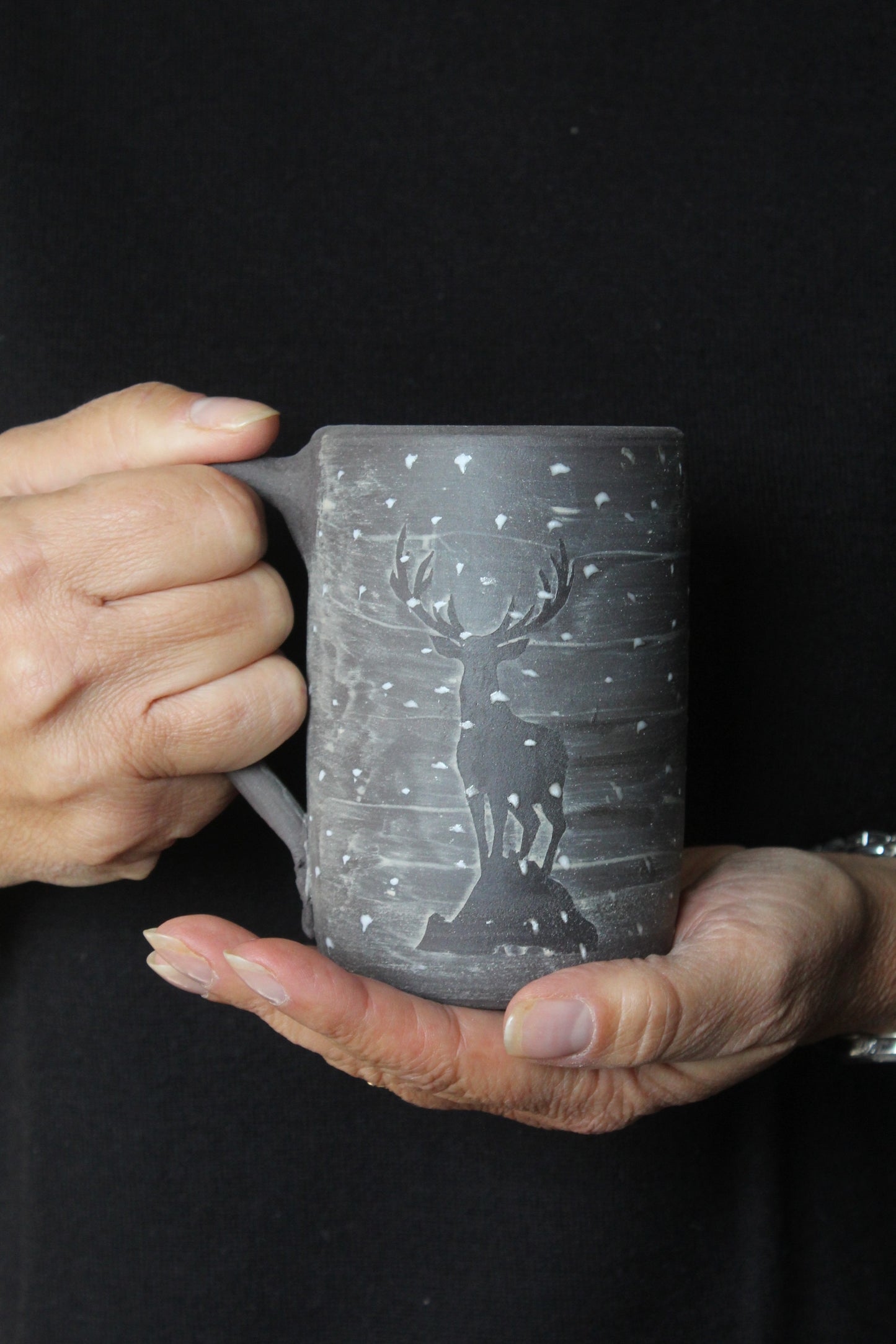 Tazza in gres nero con cervo nella neve, fatta a mano al tornio