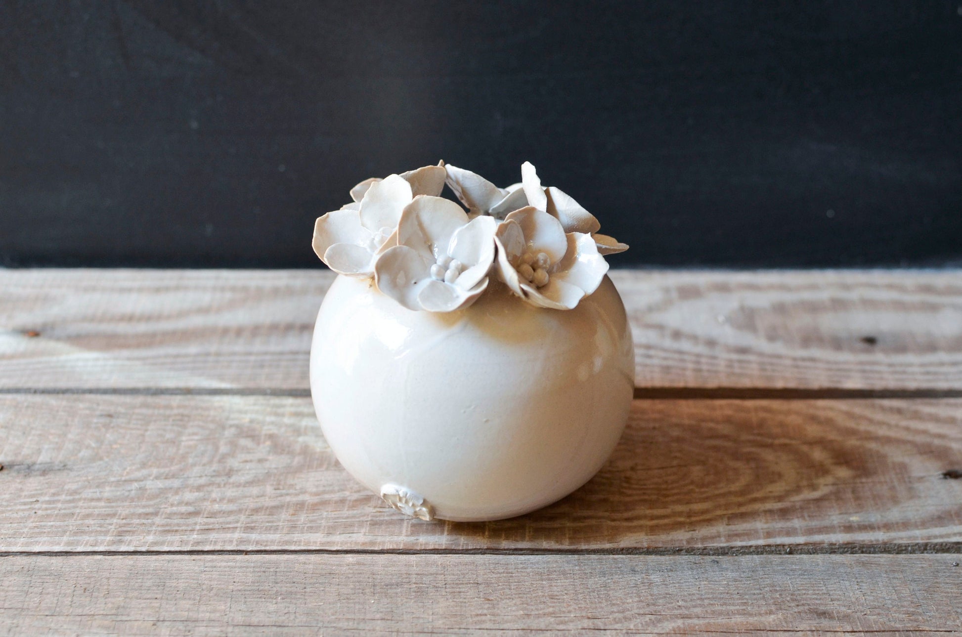 vaso sferico con fiori a quattro petali 